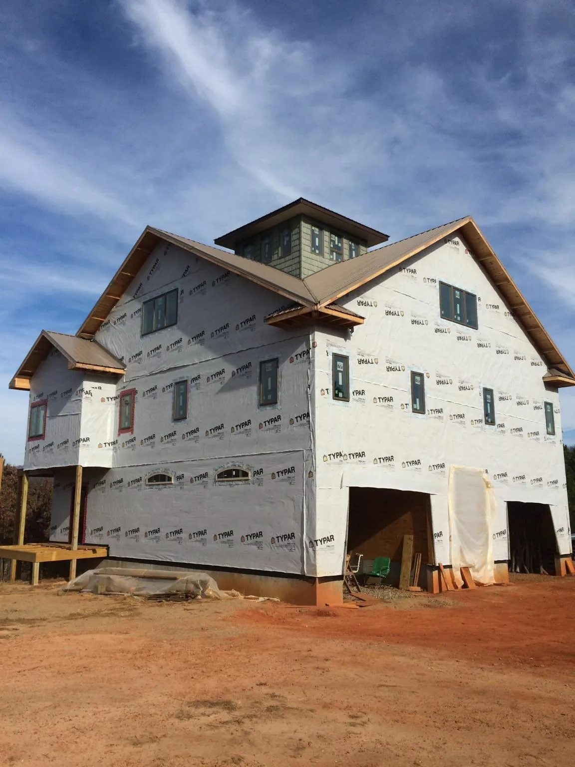New two story house under construction with a cupola and gabled roofs in Reeseville